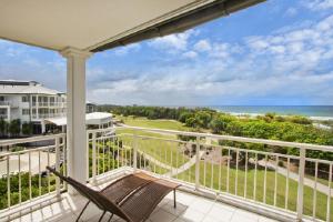 a balcony with a chair and a view of the ocean at Salt Beach Resort Suites by Kingscliff Accommodation in Kingscliff