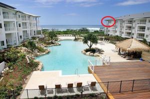 a red frisbee is flying over a swimming pool at Salt Beach Resort Suites by Kingscliff Accommodation in Kingscliff