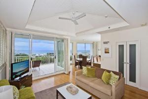 a living room with a couch and a television at Salt Beach Resort Suites by Kingscliff Accommodation in Kingscliff