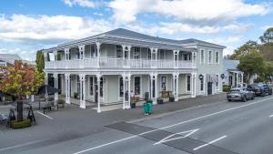 a white building with a balcony on a street at Altitude Studio in Martinborough