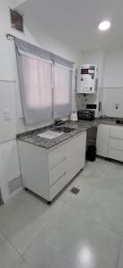 a kitchen with a sink and a microwave on a counter at Portales del Vino 2 in Tupungato