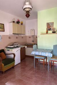 a kitchen with a table and some chairs and a table at Apartments with parking space Vis - 2436 in Vis