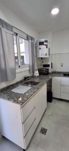 a kitchen with a sink and a microwave at Portales del Vino 2 in Tupungato
