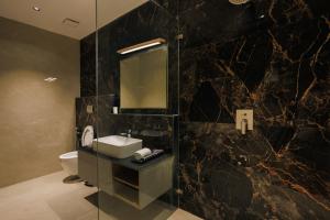 a bathroom with a sink and a mirror at Kohu By Honeyvale in Mudigere +76 photos