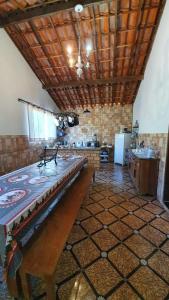 a large room with a piano in the middle of it at Camping e Pouso Recanto das Flores in Tiradentes