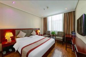 a hotel room with a large bed and a television at 古城青年旅舍 in Xi'an