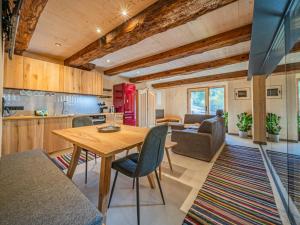a kitchen and living room with a wooden table and chairs at Raneburg 4 in Matrei in Osttirol