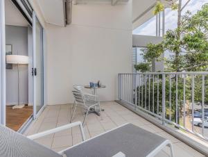 a balcony with a table and chairs on it at Salt Beach Resort Apartments by Kingscliff Accommodation in Kingscliff