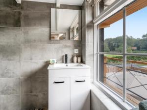 a bathroom with a white sink and a window at De Vale in Hattemerbroek +23 photos