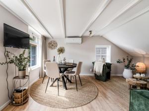 a living room with a table and chairs at De Vale in Hattemerbroek