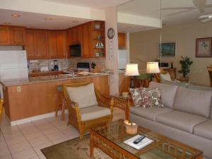 a living room with a couch and a kitchen at Napili Point Oceanfront Turtle View 1BR - Unit B30 condo in Lahaina