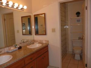 a bathroom with two sinks and a toilet at Napili Point Oceanfront Turtle View 1BR - Unit B30 condo in Lahaina