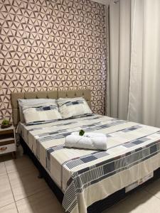 a bed with two pillows on it in a bedroom at Apto Serras Gerais 2 in Dianópolis