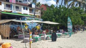 a beach with chairs and umbrellas on the sand at Beau studio au coeur du Gosier in Le Gosier