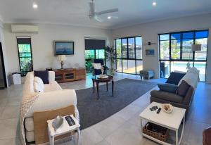 a living room with a couch and a table at Luxury Newport canal king suite home in Redcliffe