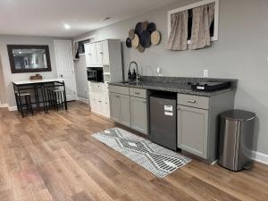 a kitchen with white cabinets and a counter top at 2BR Spacious Escape Close to DC & Baltimore in Laurel