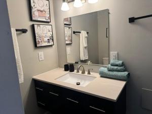 a bathroom with a sink and a mirror at 2BR Spacious Escape Close to DC & Baltimore in Laurel +14 photos
