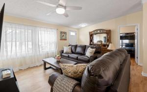 a living room with a leather couch and a table at Home Field Hideaway in Pullman