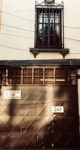 a building with a window and a clock on top at Morada Luna Roma in Mexico City