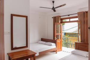 a bedroom with a mirror and a bed and a window at Heaven inn Hotel, Digana in Digana