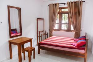 a bedroom with a bed and a mirror and a window at Heaven inn Hotel, Digana in Digana