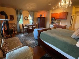 a bedroom with two beds and a kitchen with a table at The Tuwanek Bed and Breakfast in Sechelt +217 photos