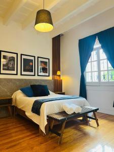 a bedroom with a bed and a blue curtain at Morada Luna Roma in Mexico City