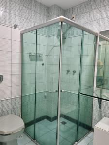 a glass shower in a bathroom with a toilet at 2-bedroom apartment in Ubá