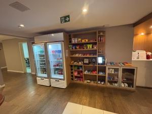 a store with two refrigerators in a room at LUXO Premium Studio Pelinca in Campos dos Goytacazes
