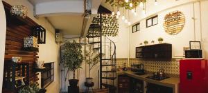 a kitchen with plants on the wall and a spiral staircase at Morada Luna Roma in Mexico City