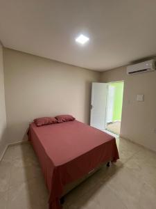 a bedroom with a bed in a room with a refrigerator at chacara por do sol in Piranhas
