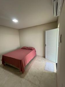 a bedroom with a bed and a sliding door at chacara por do sol in Piranhas