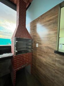 a brick oven in a room with a window at chacara por do sol in Piranhas