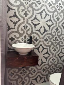 a bathroom with a sink and a tile wall at Morada Luna Roma in Mexico City +53 photos