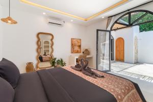 a bedroom with a bed with sandals on the bed at Chic 2BR Private Pool Villa in Canggu in Dalung +58 photos