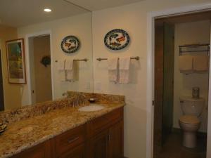 a bathroom with a sink and a toilet and a mirror at Peaceful Ocean-View 2BR Loft Escape - Unit C38 condo in Lahaina