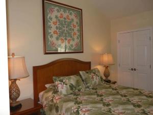 a bedroom with a bed with two lamps and a picture on the wall at Peaceful Ocean-View 2BR Loft Escape - Unit C38 condo in Lahaina