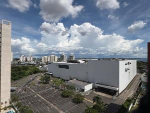 an aerial view of a large white building with a parking lot at Apartment in Ponta Negra in Manaus