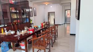 a dining room with a long table and chairs at 道和轩民宿 in Heyuan