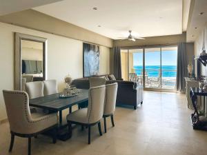 a dining room with a table and chairs and the ocean at Beachfront Condo with Stunning Views Tranquil Stay in Puerto Peñasco
