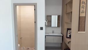 a small bathroom with a sink and a toilet at 道和轩民宿 in Heyuan +29 photos