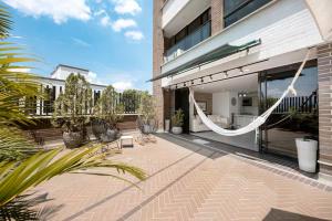 a patio with a hammock outside of a building at Luxury Jacuzzi in Poblado in El Poblado