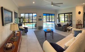 a living room with a couch and a table at Luxury Newport canal king suite home in Redcliffe