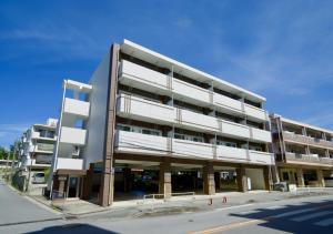 a large building on the side of a street at Luana Lea Karate Kaikan Mae in Tomigusuku