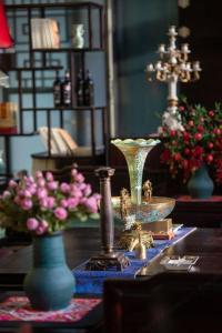 a table with vases and flowers on a table at Zishui Qinglu Manor in Sanya