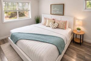 a bedroom with a large white bed with pillows at Private Riverfront Estate with Kayaks & Views in Post Falls