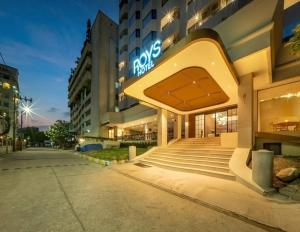 a hotel with a sign on the side of a building at ROYS Hotel Bangkok in Bangkok