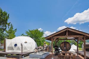 a large white camper on display in a park at From P in Hakuba