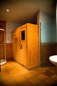 a bathroom with a wooden cabinet and a sink at Hotel Mediterraneo in Benidorm