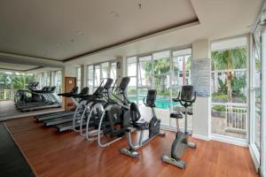 a gym with several treadmills and elliptical machines at Vida View Apartment by Vida Connect in Makassar